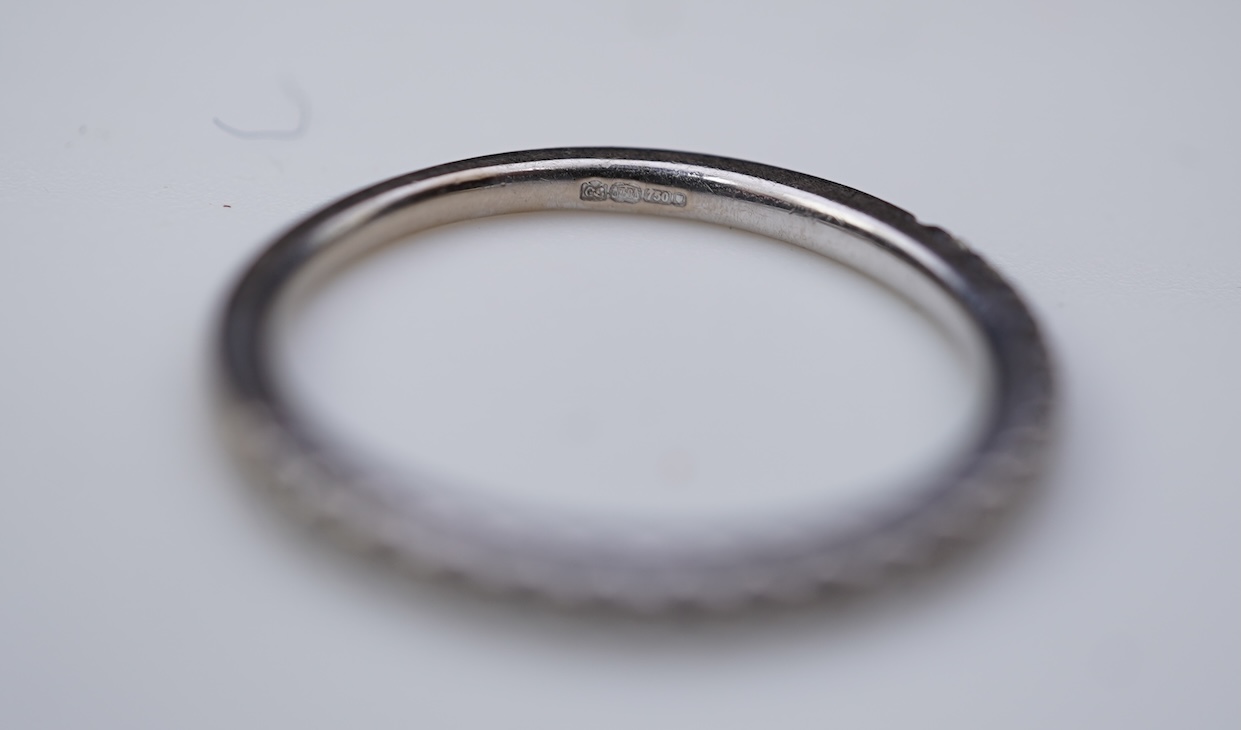 A diamond engagement ring and half eternity ring